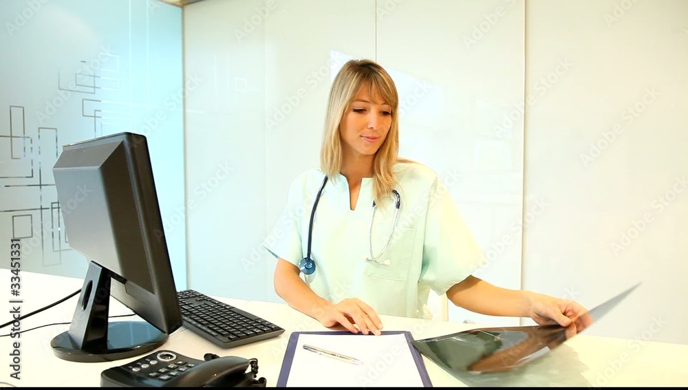 Nurse in office looking at Xray