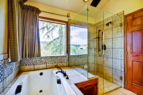 Bathroom with natural tiles and glass shower