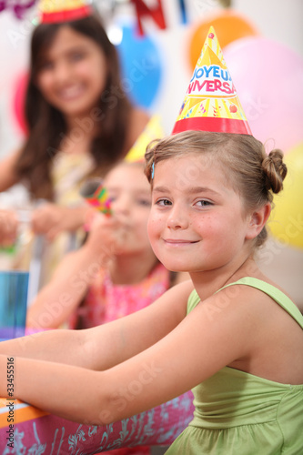 a little girl and her friends at a birthday party