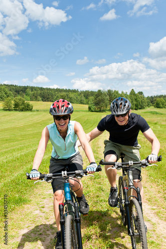 Sport mountain biking - man pushing young girl