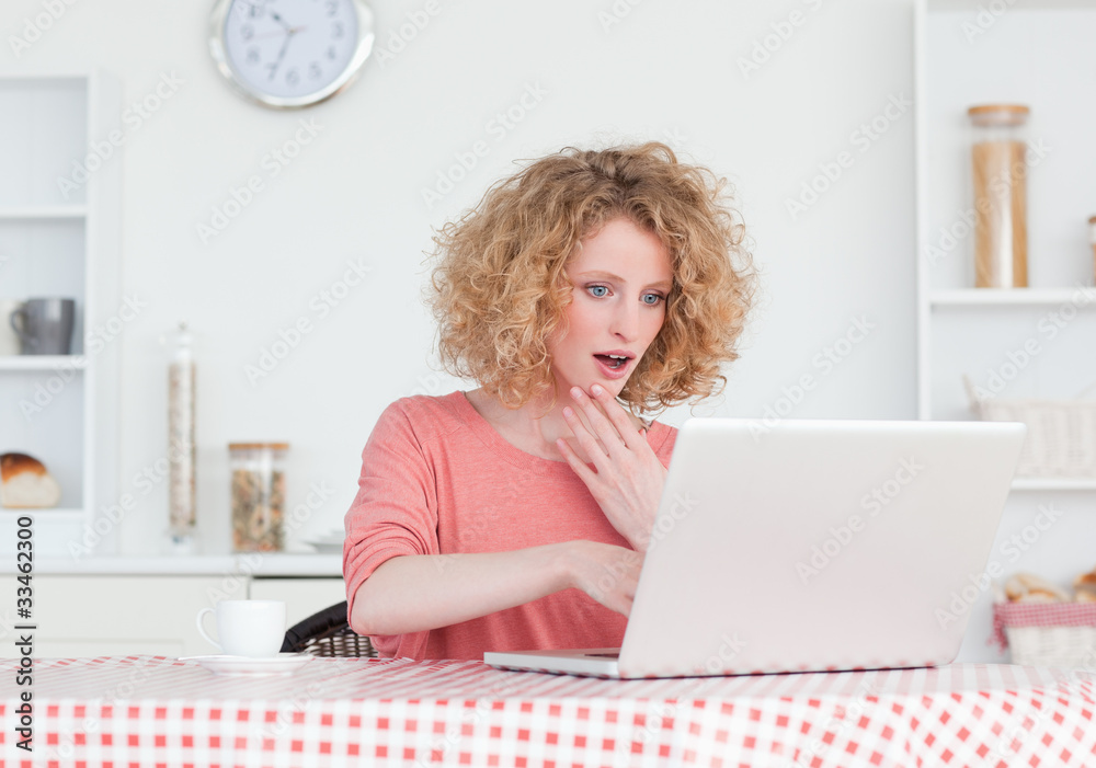 Attractive blonde female relaxing with her laptop while sitting Attractive blonde female relaxing with her laptop while sitting