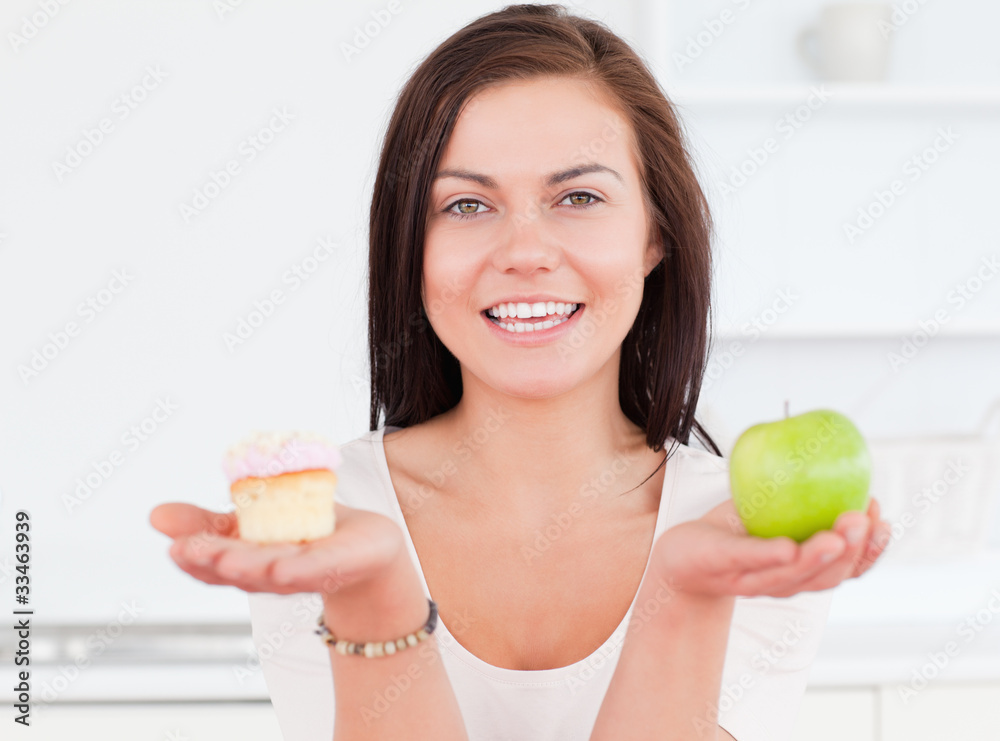 Young woman with an apple and a piece of cake Young woman with an apple and a piece of cake