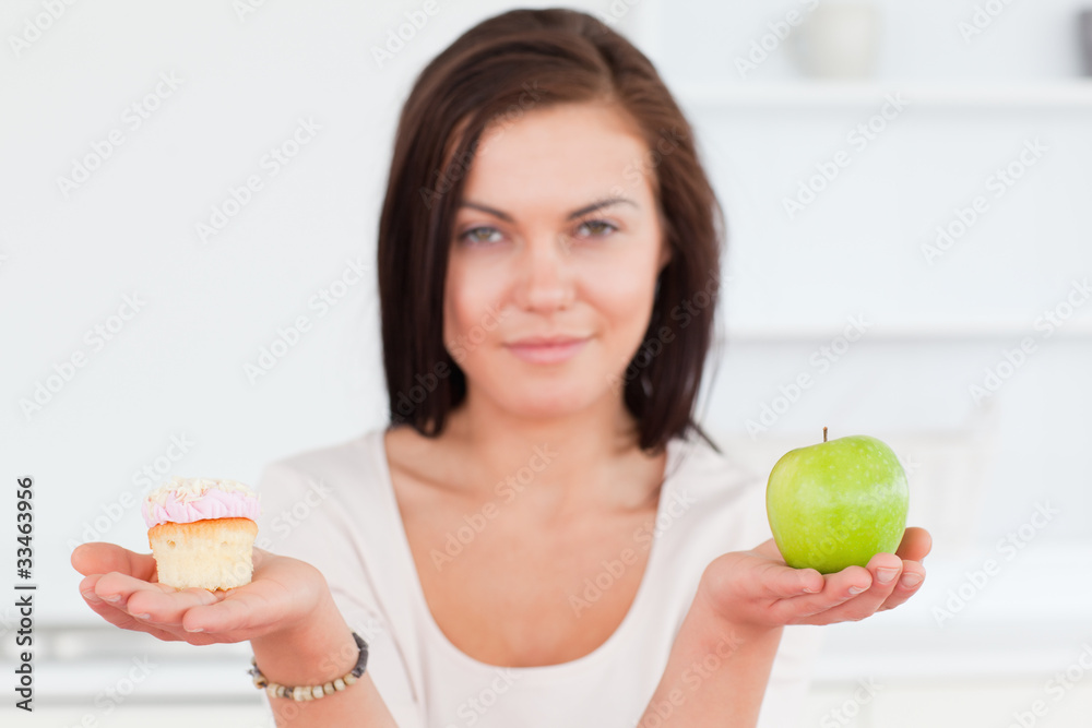 Charming brunette with an apple and a piece of cake Charming brunette with an apple and a piece of cake