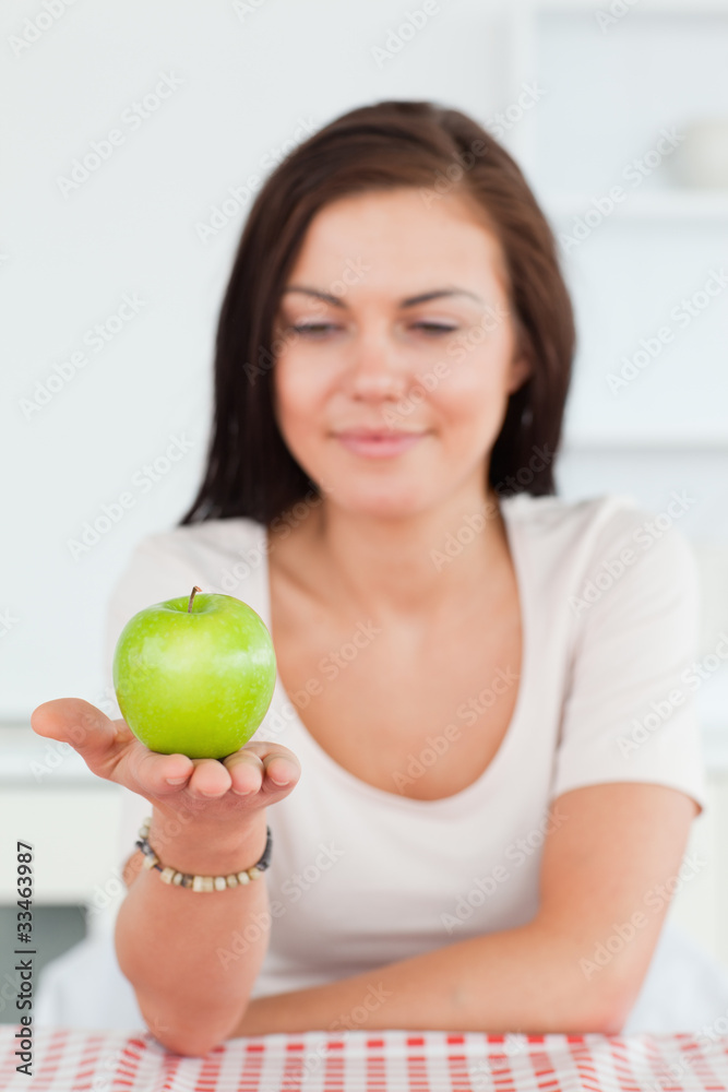 Smiling woman showing an apple Smiling woman showing an apple