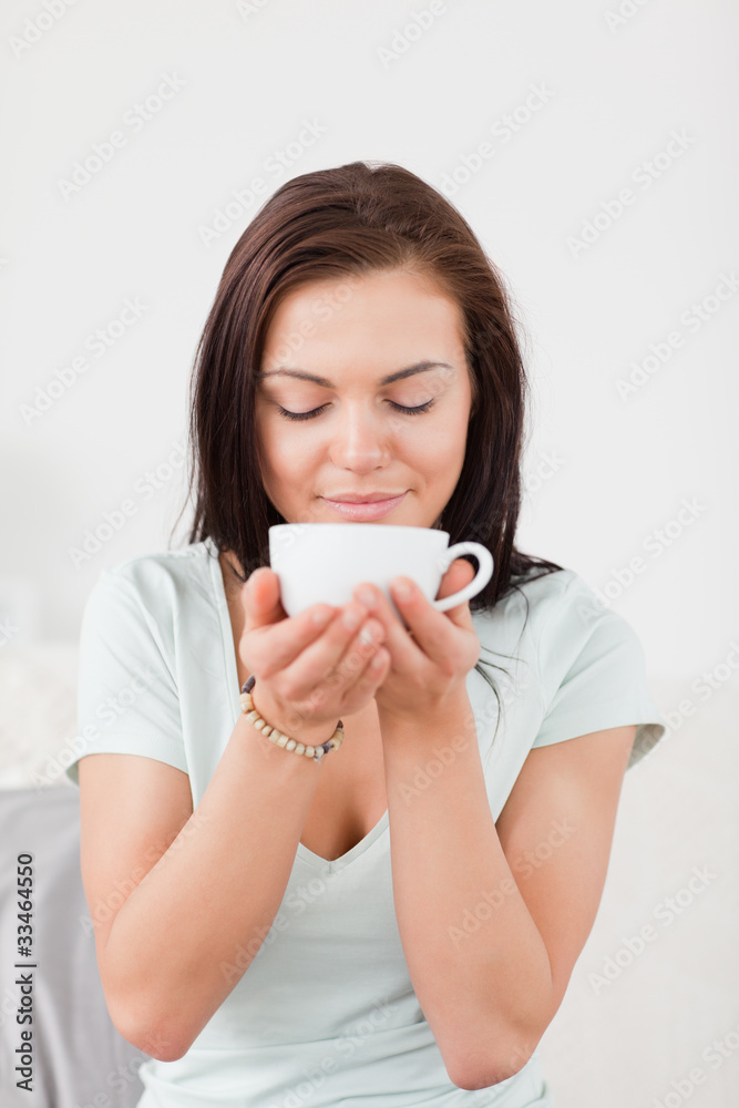 Portrait of a dark-haired woman drinking coffee Portrait of a dark-haired woman drinking coffee