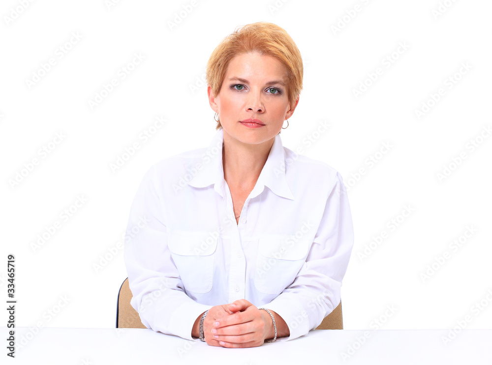 Blond smiling businesswoman sitting at her desk Blond smiling businesswoman sitting at her desk