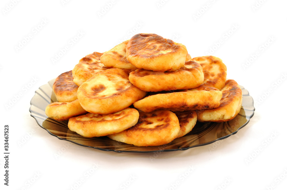 Several golden cheese pancakes on black glass plate