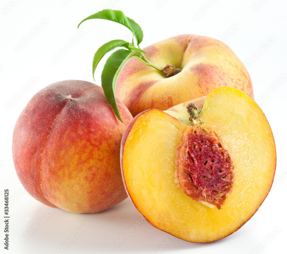 Ripe peach fruit with leaves and slises Ripe peach fruit with leaves and slises