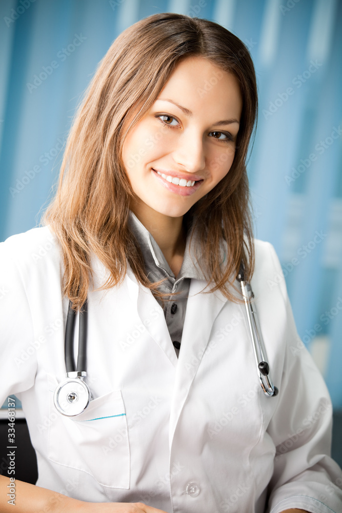 Portrai of happy smiling young female doctor at office Portrai of happy smiling young female doctor at office
