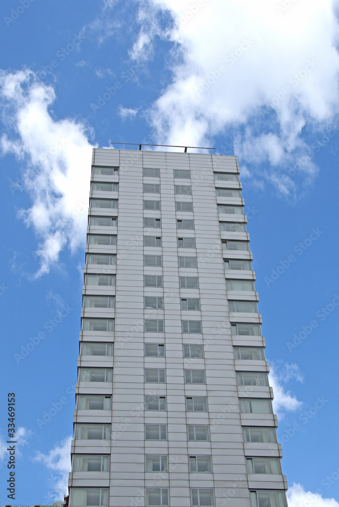 Grey Apartment Block against a blue sky Grey Apartment Block against a blue sky