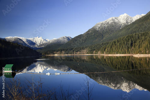 Fototapeta Naklejka Na Ścianę i Meble -  Capilano Reservoir Lake Snowy Two Lions Mountains Vancouver Brit