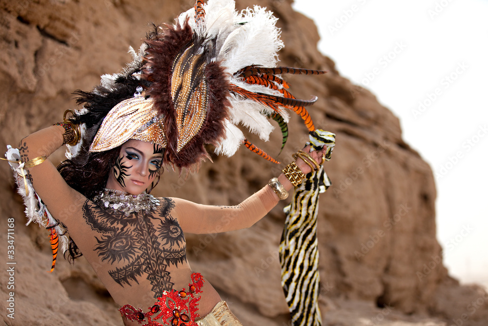 Tribal Female Wearing a Feather Head Gear Posing Outside