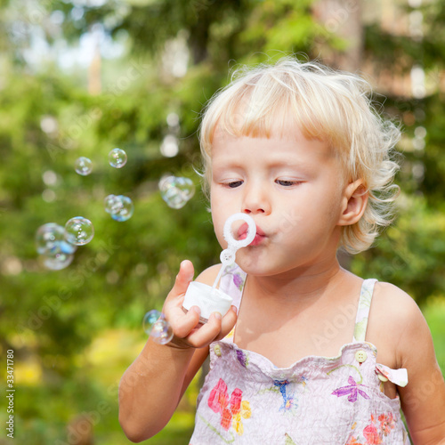 Little girl making bubbles