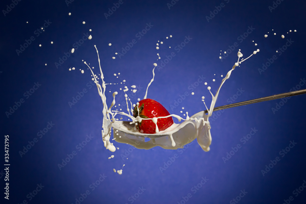 strawberry splashing in milk