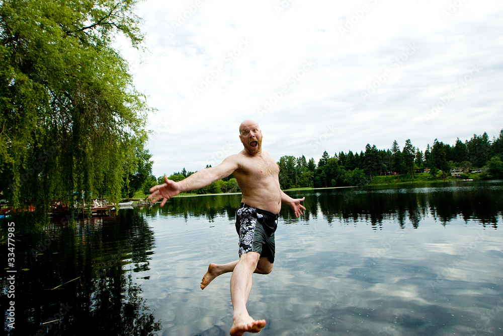 Fototapeta premium Man jumping in a lake
