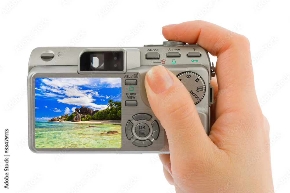 Hand with camera and beach landscape (my photo)