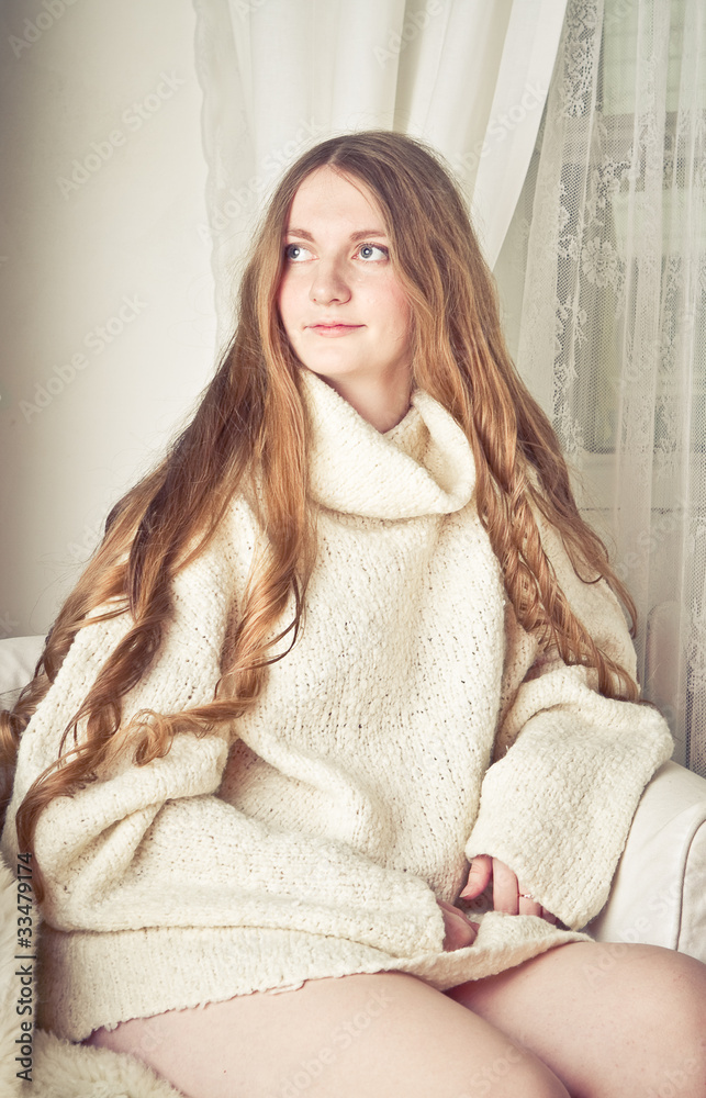 Beautiful young pregnant woman sitting on sofa Beautiful young pregnant woman sitting on sofa