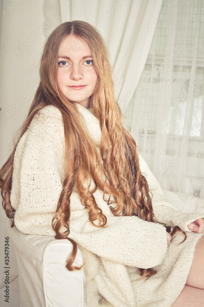 Beautiful young pregnant woman sitting on sofa Beautiful young pregnant woman sitting on sofa