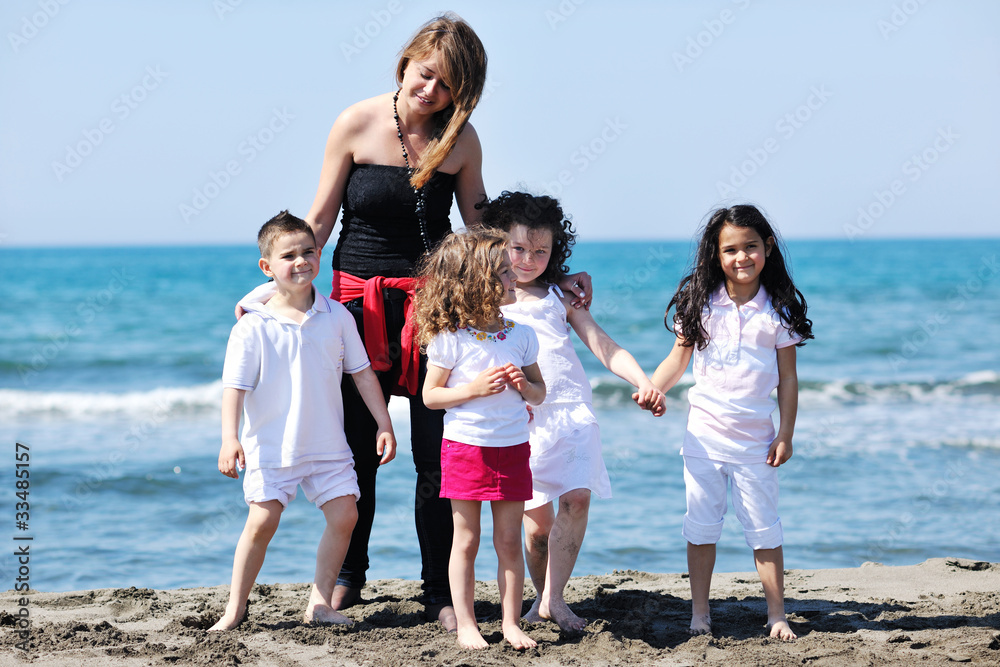 group portrait of childrens with teacher on beach group portrait of childrens with teacher on beach