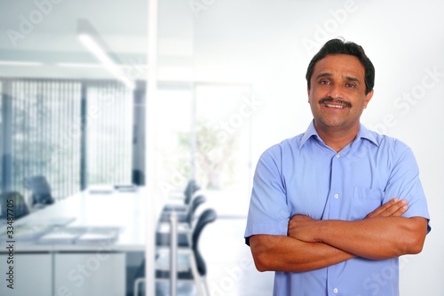 Indian latin businessman blue shirt in modern office