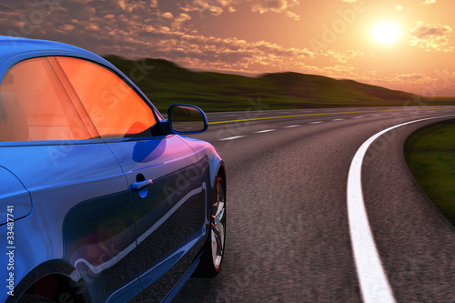 Blue car driving by autobahn in sunset with motion blur © Scanrail