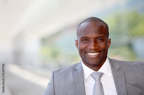 Portrait of handsome businessman wearing grey suit
