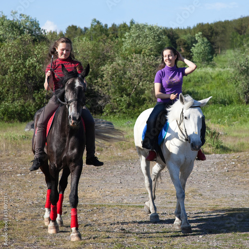 Two girls riding horses © aleksandrn