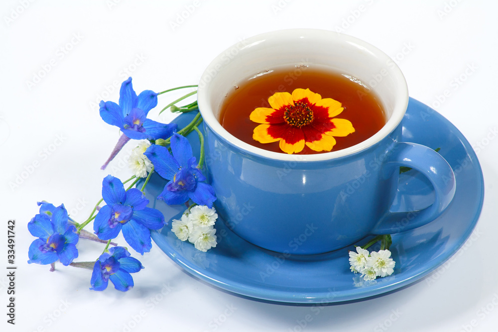 The blue cup of tea with nice flowers The blue cup of tea with nice flowers
