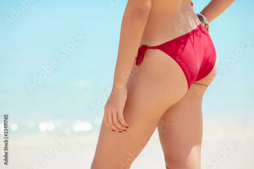 pretty young woman with red swimsuit near the sea