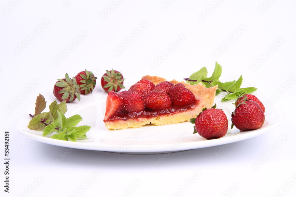 Piece of Strawberry Tart decorated with strawberries and mint Piece of Strawberry Tart decorated with strawberries and mint