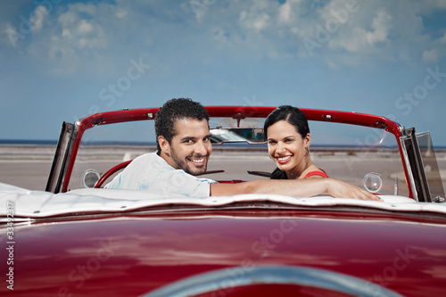 man and beautiful woman hugging in cabriolet car