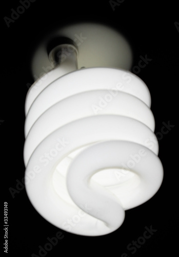 Lit energy saving light bulb photo