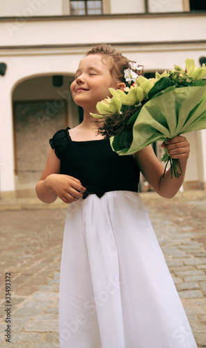 Little girl with a beautiful bouquet of flowers