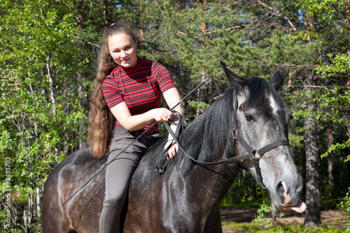 Beautiful girl on black horse