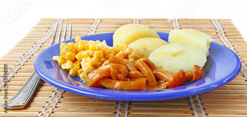 Fototapeta Naklejka Na Ścianę i Meble -  Mushrooms and potato, with a corn on dark blue a dish.