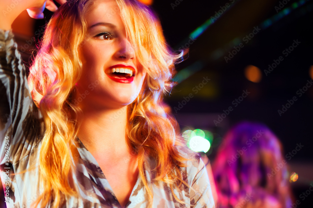 Woman in club or bar having fun (motion blur!)