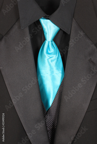 Closeup of three piece suit with blue tie