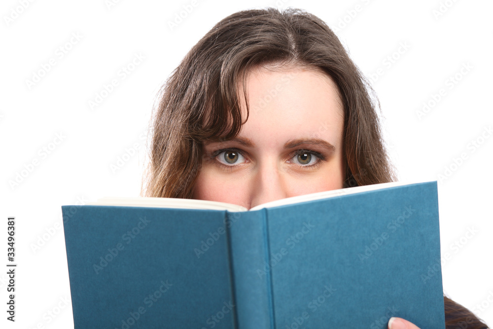 Green eyes of woman looks up from reading a book Green eyes of woman looks up from reading a book