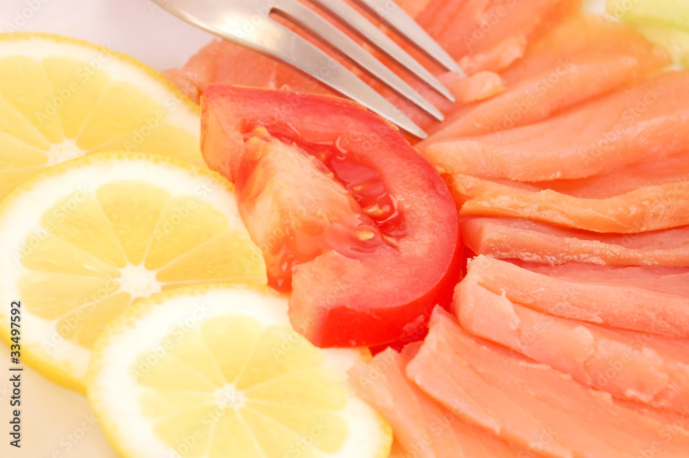 Fresh salmon steak with lemon slice and tomato Fresh salmon steak with lemon slice and tomato