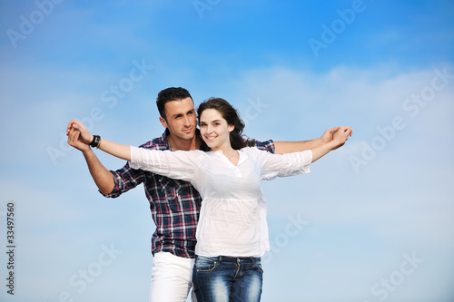 happy young couple have fun on beach