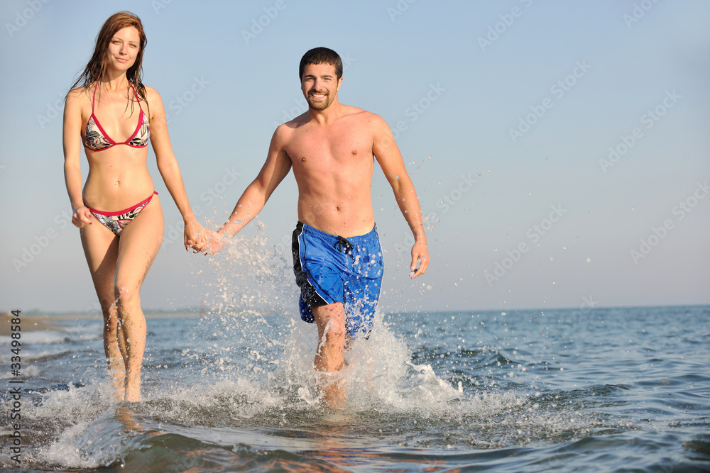 happy young couple have fun on beach happy young couple have fun on beach