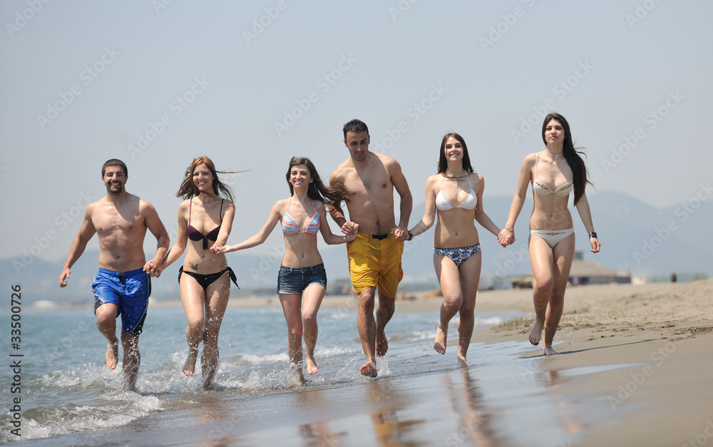 happy young  people group have fun on beach