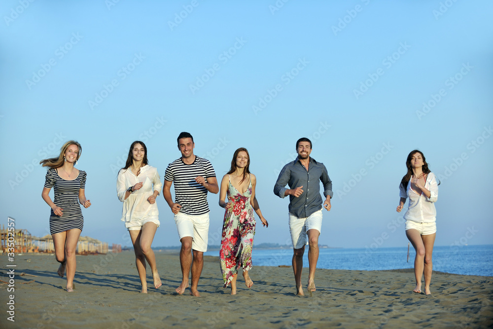 happy young  people group have fun on beach