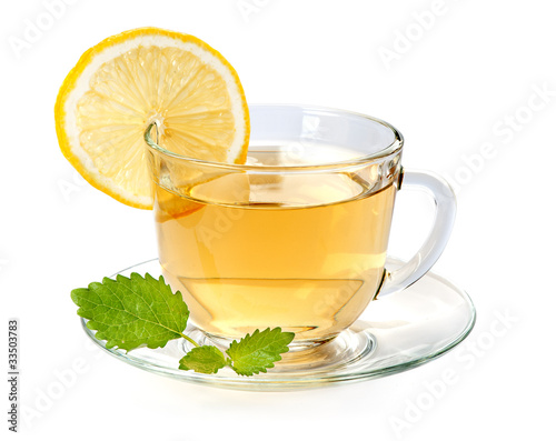 Glass cup of tea with lemon and leaf mint