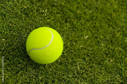 Tennis ball on a lawn court