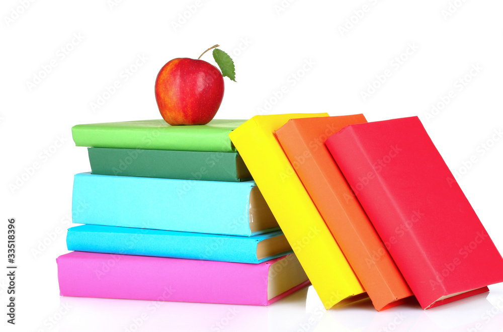 Books and apple isolated on white