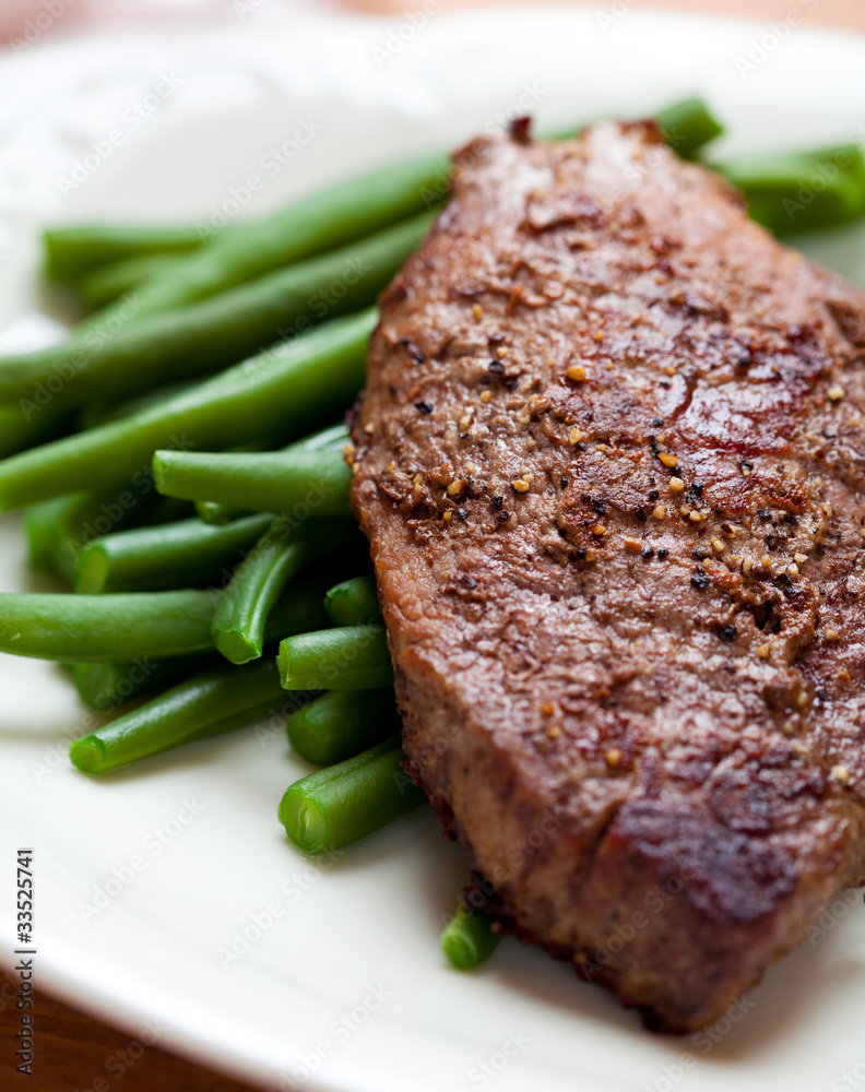 Closeup of steak with french beans