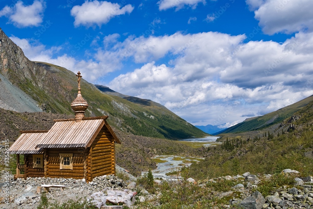 wooden christian church in a mountain valley