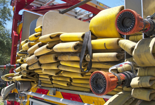 Up close view of a yellow fire hose on a firetruck