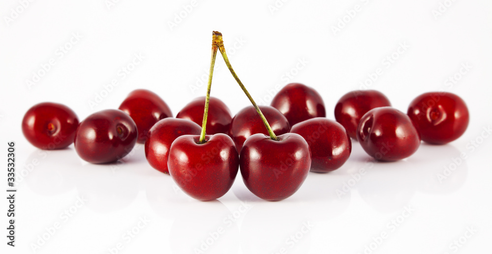 two cherries with stems in front of cherry two cherries with stems in front of cherry